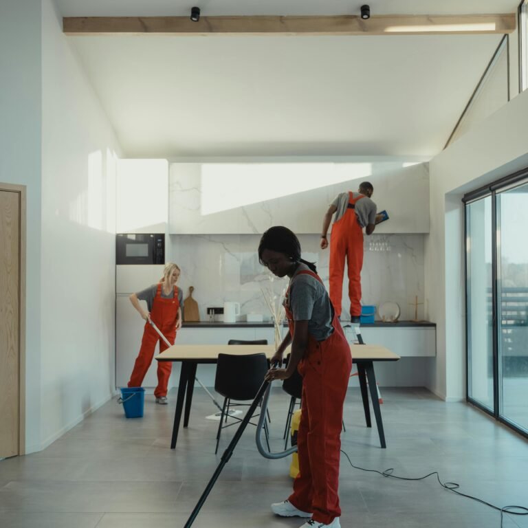 A diverse group of professionals cleaning a modern home interior.